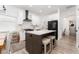 Bright kitchen featuring white cabinetry, subway tile backsplash, stainless steel appliances, and a gray island with a white countertop at 6116 Skylarkcrest Dr, Lithia, FL 33547