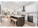 Open-concept kitchen featuring an island with bar seating, white cabinets and stainless steel appliances at 6116 Skylarkcrest Dr, Lithia, FL 33547