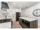 Modern kitchen with white cabinets, stainless steel appliances, and an island with a quartz countertop and built-in microwave at 6116 Skylarkcrest Dr, Lithia, FL 33547