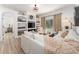 Bright living room featuring built-in shelving, a comfortable sofa, and large windows offering natural light at 6116 Skylarkcrest Dr, Lithia, FL 33547