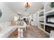 Inviting living room flowing into kitchen and dining area, featuring neutral decor, an accent rug and built-in fireplace at 6116 Skylarkcrest Dr, Lithia, FL 33547