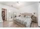 Comfortable bedroom featuring wood-look floors, ensuite bathroom, and spacious walk-in closet for easy storage at 6116 Skylarkcrest Dr, Lithia, FL 33547