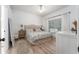 Bright main bedroom with a ceiling fan, wood-look floors, and a large window providing ample natural light at 6116 Skylarkcrest Dr, Lithia, FL 33547