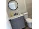 This bathroom features a gray vanity, a new toilet and white marbled countertops at 613 Coronet St, Plant City, FL 33563