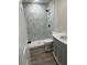 Bathroom featuring modern fixtures and elegant marbled tiling in the shower at 613 Coronet St, Plant City, FL 33563
