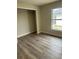 This cozy bedroom features new wood grain vinyl flooring and closet space at 613 Coronet St, Plant City, FL 33563