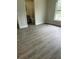 Primary bedroom featuring vinyl floors, a bathroom, and natural light at 613 Coronet St, Plant City, FL 33563