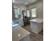Modern kitchen featuring stainless steel appliances, quartz countertops and wood grain vinyl floors at 613 Coronet St, Plant City, FL 33563