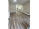 The living room showcases new wood grain vinyl flooring and fresh paint at 613 Coronet St, Plant City, FL 33563