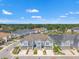 A stunning aerial view of the townhome community with a picturesque pond and lush greenery at 6731 Rocky Park St, Tampa, FL 33625