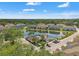 Aerial view of community homes surrounding a pond with a community pool and lush green landscaping at 6731 Rocky Park St, Tampa, FL 33625
