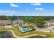 Beautiful aerial view of a community pool surrounded by lush landscaping and well-maintained homes under a clear blue sky at 6731 Rocky Park St, Tampa, FL 33625