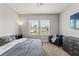 Bright bedroom featuring a comfy bed, ceiling fan, and natural light from two windows at 6731 Rocky Park St, Tampa, FL 33625
