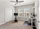 Bright bedroom featuring carpeted floors, a ceiling fan, and a stationary bike at 6731 Rocky Park St, Tampa, FL 33625