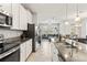 Open-concept kitchen flows into living area, featuring granite counters and stainless steel appliances at 6731 Rocky Park St, Tampa, FL 33625