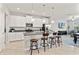 Bright kitchen showcasing white cabinets, stainless appliances, and a large island with bar seating at 6731 Rocky Park St, Tampa, FL 33625