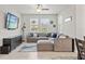 Spacious living room with tile flooring, comfortable sectional seating, and a wall-mounted television at 6731 Rocky Park St, Tampa, FL 33625