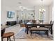 A dining area flows into the living room with plush seating and a wall-mounted TV at 6731 Rocky Park St, Tampa, FL 33625