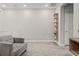 A carpeted sitting area is staged with minimal decor and a comfortable gray couch at 6731 Rocky Park St, Tampa, FL 33625