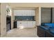 Outdoor kitchen and seating area features white cabinets, granite counters, and a mini fridge at 6731 Rocky Park St, Tampa, FL 33625