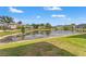 Scenic view of a community pond surrounded by well-maintained lawns and houses at 6731 Rocky Park St, Tampa, FL 33625