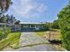 Charming green home with a fenced yard and paved driveway, offering curb appeal and privacy at 6904 11Th Ave E, Palmetto, FL 34221
