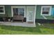 View of the front porch with a bench, door, and windows of the exterior of this home at 6904 11Th Ave E, Palmetto, FL 34221