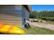 View of exterior shed area with a yellow kayak, equipment, and a glimpse of the nearby waterway at 6904 11Th Ave E, Palmetto, FL 34221