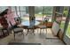 Sunroom featuring an outdoor view, a glass top table, and four chairs at 6904 11Th Ave E, Palmetto, FL 34221