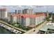 Beautiful waterfront condo building with a pool, boat dock, and tropical landscaping at 700 S Harbour Island Blvd # 740, Tampa, FL 33602