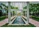 Beautiful courtyard with water feature, pergola, and lush tropical landscaping creates a serene oasis at 700 S Harbour Island Blvd # 740, Tampa, FL 33602