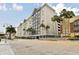 Multi-story gray condo with palm trees and well-maintained landscaping shows curb appeal and tropical charm at 700 S Harbour Island Blvd # 740, Tampa, FL 33602