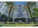 Multi-story gray condo building with palm trees and manicured landscaping shows curb appeal at 700 S Harbour Island Blvd # 740, Tampa, FL 33602