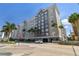 Beautiful multi-story condo building in gray and white, enhanced by palm trees, under a bright blue sky at 700 S Harbour Island Blvd # 740, Tampa, FL 33602