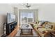 Comfortable living room with hardwood floors, sectional sofa, and large windows with urban views at 700 S Harbour Island Blvd # 740, Tampa, FL 33602