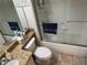 Bright bathroom features a tub/shower combo with glass door, granite vanity top, and neutral tile flooring at 716 Seagate Dr # 716, Tampa, FL 33602