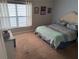 Comfortable bedroom features a large window letting in natural light and neutral carpet at 716 Seagate Dr # 716, Tampa, FL 33602