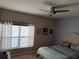 Comfortable bedroom features a ceiling fan and a large window letting in natural light at 716 Seagate Dr # 716, Tampa, FL 33602