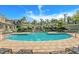 A large and luxurious community pool is surrounded by lounge chairs and lush landscaping under a sunny sky at 716 Seagate Dr # 716, Tampa, FL 33602