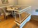 Dining area with hardwood floors, seating for four and a white railing overlooking a staircase at 716 Seagate Dr # 716, Tampa, FL 33602