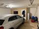 Spacious garage with a car provides ample storage and parking with clean white walls at 716 Seagate Dr # 716, Tampa, FL 33602