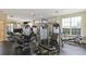 Bright gym with multiple machines, rubber flooring, and large windows for natural lighting at 716 Seagate Dr # 716, Tampa, FL 33602