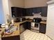 Kitchen with stainless steel appliances, dark wood cabinets, granite counters and tile floors at 716 Seagate Dr # 716, Tampa, FL 33602