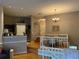 Open concept living room with hardwood floors, chandelier, dining area, and kitchen area with granite counters at 716 Seagate Dr # 716, Tampa, FL 33602