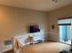 Bright living room featuring hardwood floors, a sliding glass door to a patio, and neutral paint at 716 Seagate Dr # 716, Tampa, FL 33602