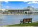 A bench overlooks the waterfront with modern buildings and inviting dining spots at 716 Seagate Dr # 716, Tampa, FL 33602