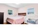 Bright bedroom featuring wood floors, a window and a crib at 7428 36Th N Ave, St Petersburg, FL 33710