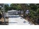 Attractive single-story home with a long driveway, a basketball hoop, and mature trees at 7428 36Th N Ave, St Petersburg, FL 33710