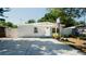 Charming single-story home with a well-manicured lawn, basketball hoop, and a long driveway at 7428 36Th N Ave, St Petersburg, FL 33710