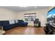 Comfortable living room with hardwood floors, blue sofa, and large TV with views of the snow-capped mountain at 7428 36Th N Ave, St Petersburg, FL 33710